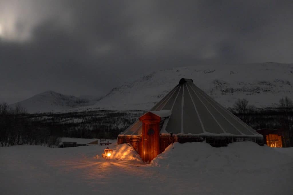 All about visiting Camp Tamok with Lyngsfjord Adventures outside of Tromso, Norway | A trip to the Arctic Circle in winter calls for an epic experience. We went dog sledding & slept in a traditional Sami lavvu tent, ate delicious food & soaked in stunning views | What to do in Tromso, sleeping in a Sami tent, Arctic adventures, mushing, dog sledding in Norway, what to do in Norway #tromso #norway #lyngsfjord #camptamok