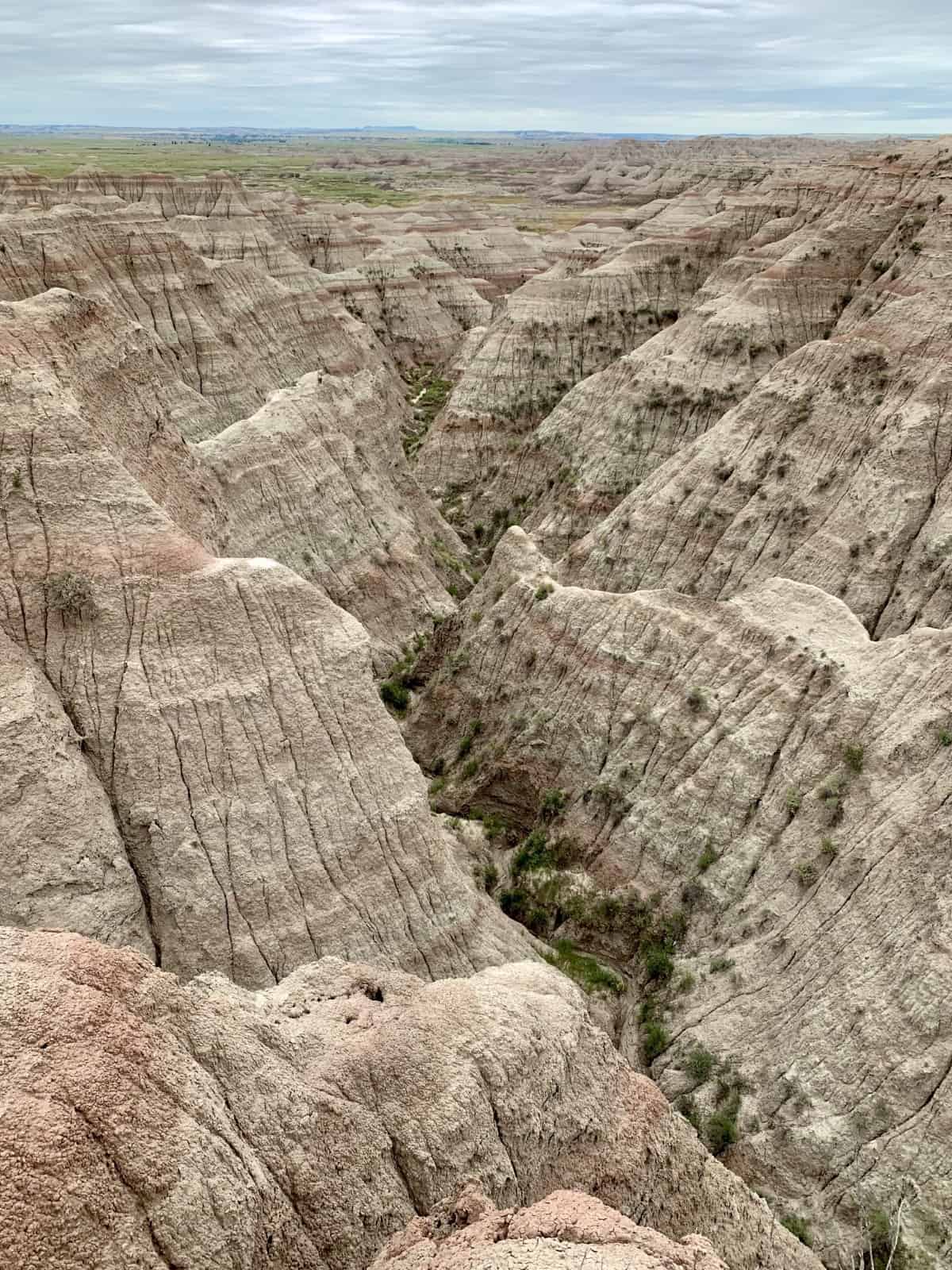 Planning a Trip to Badlands National Park | Why a roadtrip to South Dakota's Badlands is a must, and an easy day trip from Rapid City. What route to take, costs, things to do in Badlands, where to stop, and many more tips (including a stop at Wall Drug!). South Dakota roadtrip ideas, visiting national parks, social distance roadtrip ideas. #southdakota #nationalpark #nps #badlands #roadtrip