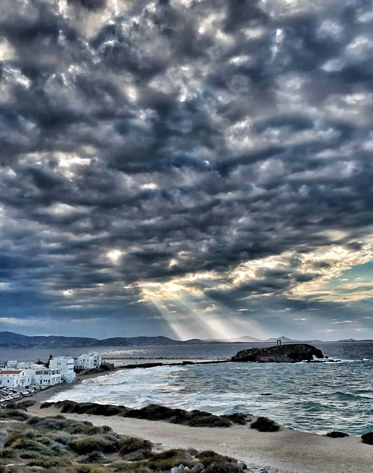 A cloudy but dramatic sunset over the Portara in Naxos Town
