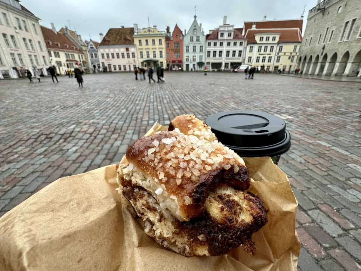 Things to do in Tallinn, Estonia - a cinnamon bun with a view of Town Hall Square