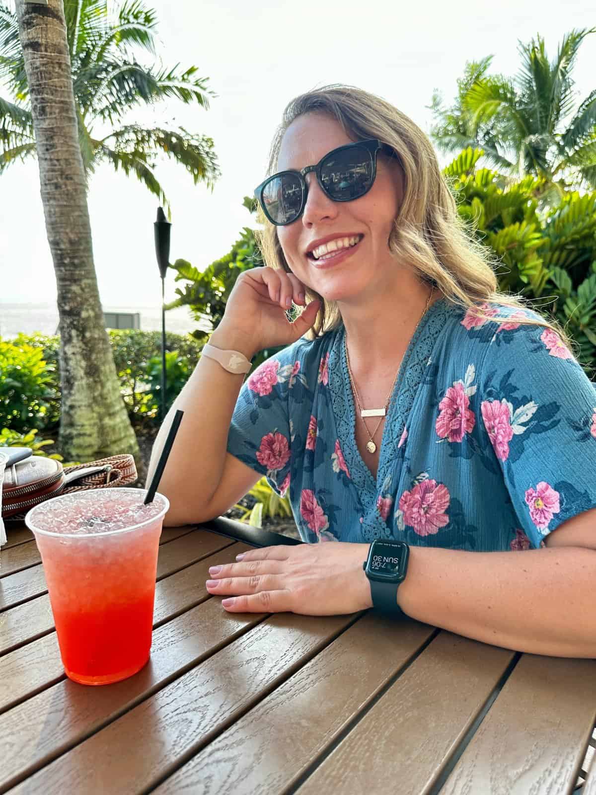 girl smiling with red cocktail tiki bar